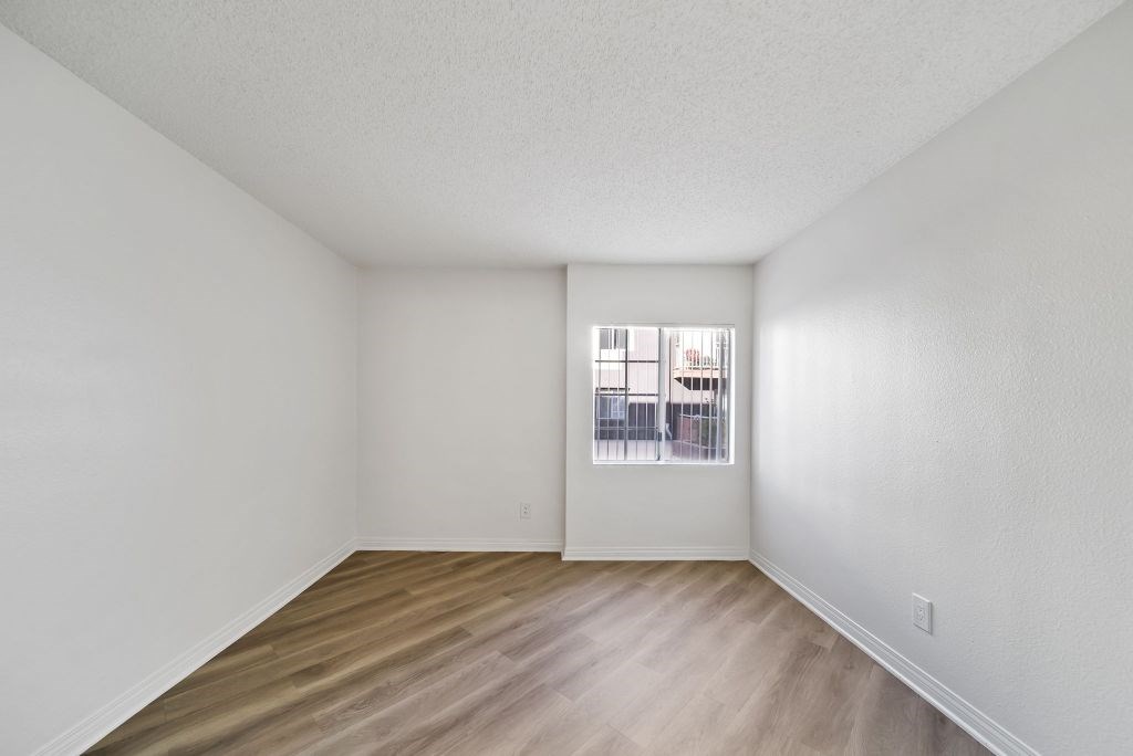Empty room with wooden floor and white walls.