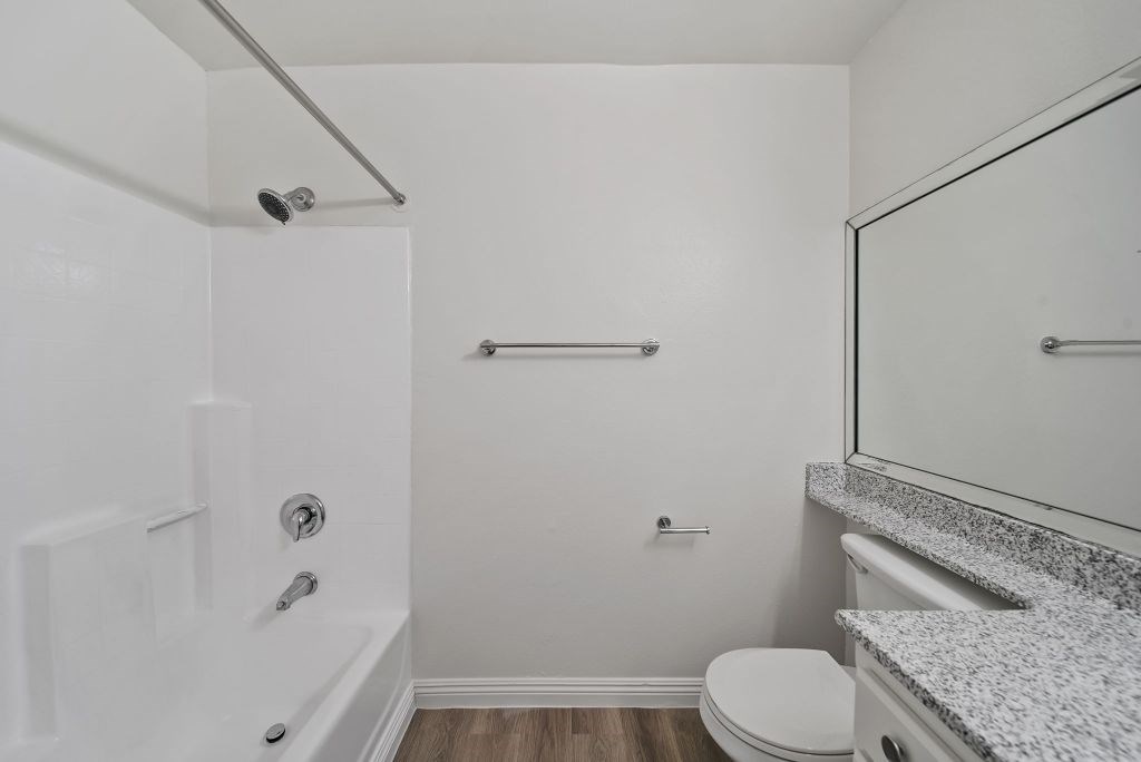 A white bathroom with a toilet, sink, and bathtub.