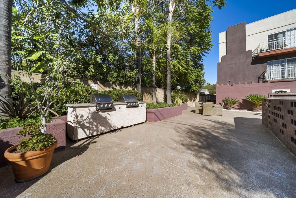 A courtyard with a concrete floor and a wall with a window.