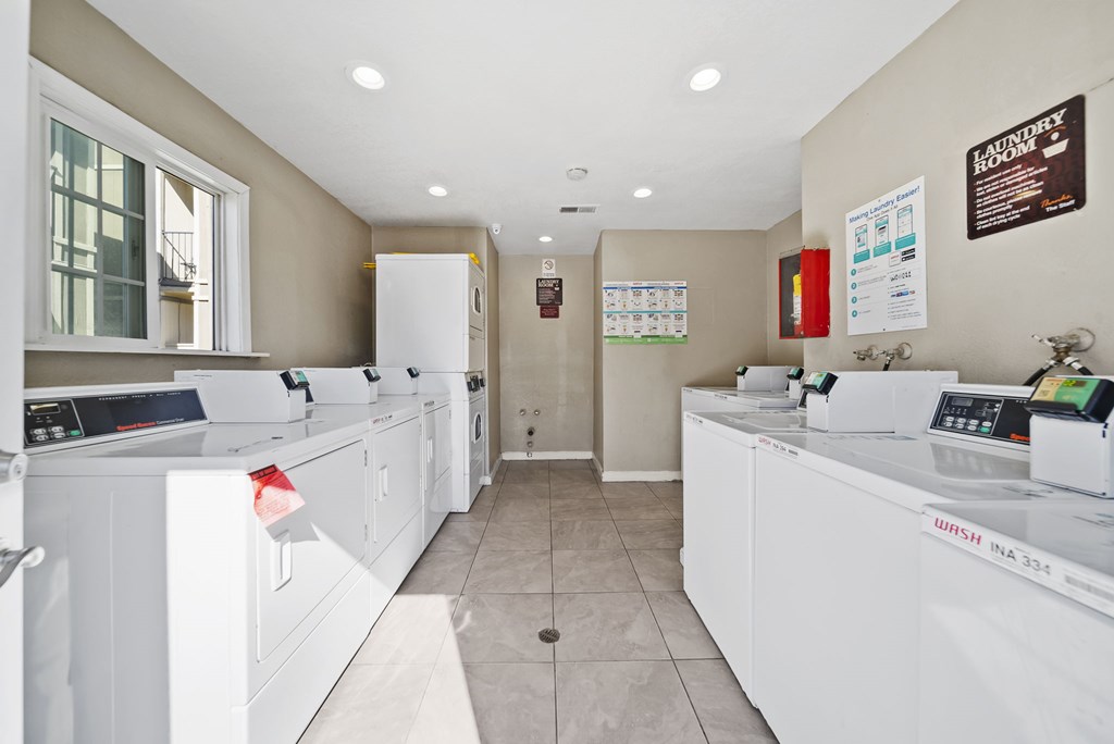 A laundry room with washers and dryers.