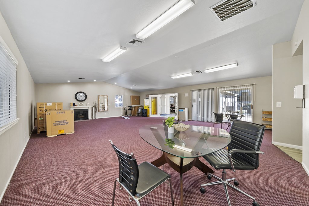 A conference room with a glass table and chairs.