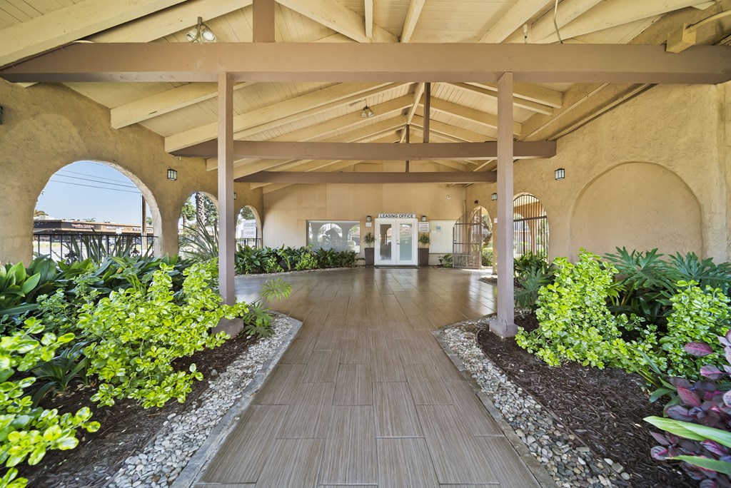 A long wooden walkway leads through a landscaped garden.