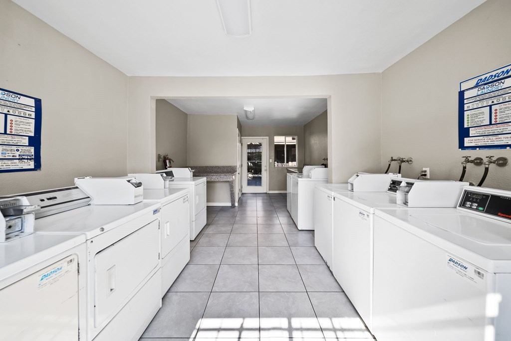 A laundromat with rows of washers and dryers.