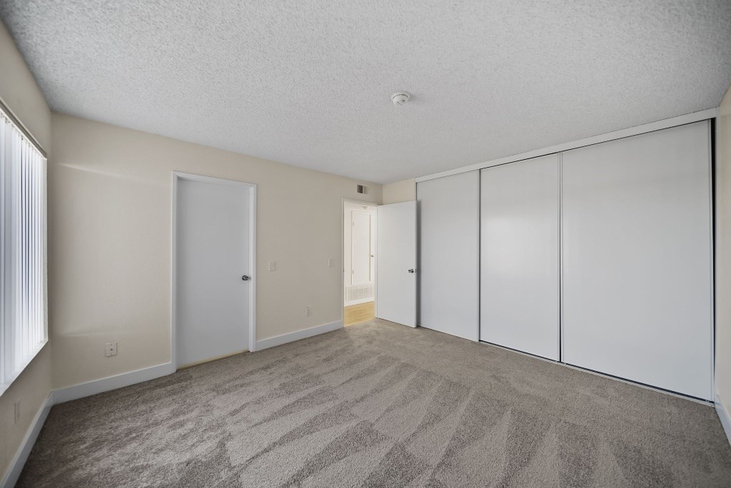 A room with a carpeted floor and white walls.