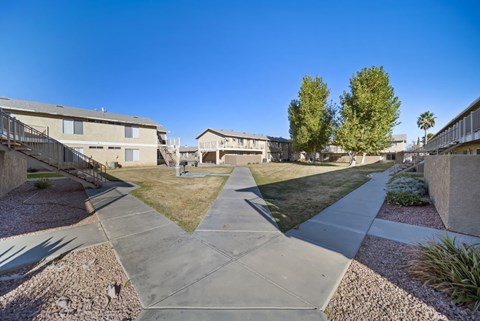 A sunny day in a residential area with houses and trees.