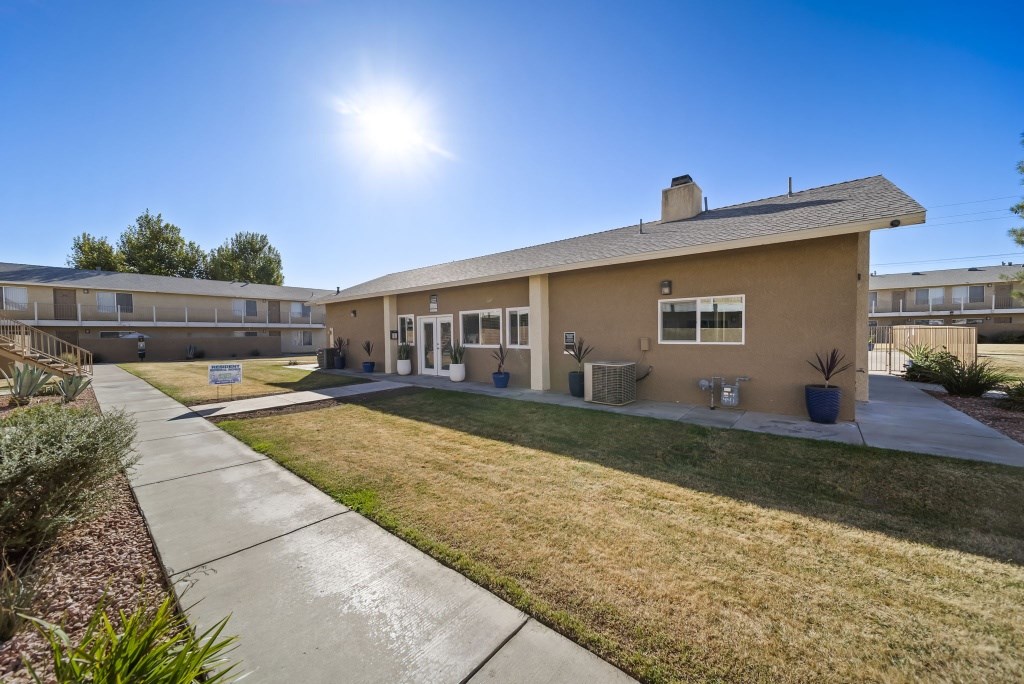 A sunny day at a residential complex with a clear blue sky.