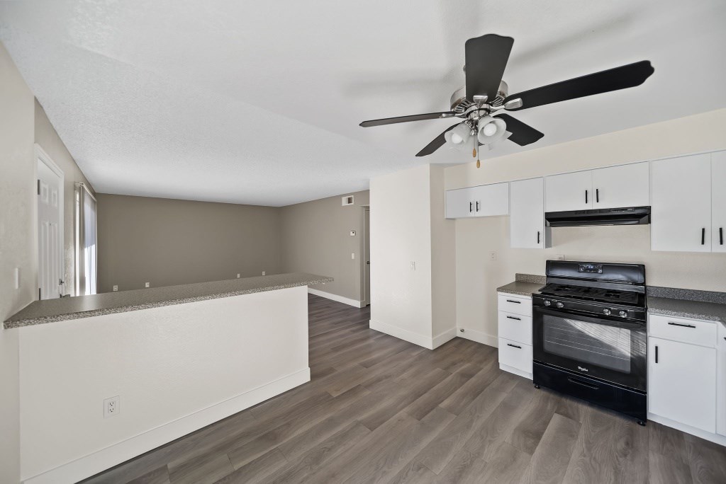 A modern kitchen with a black stove top oven.