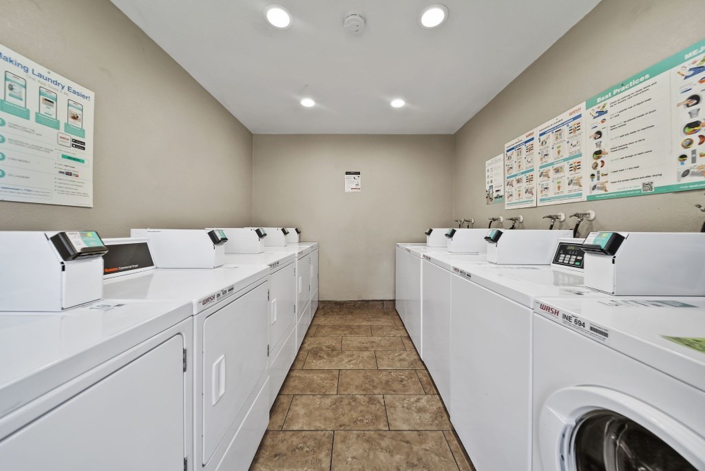 A laundromat with rows of washers and dryers.