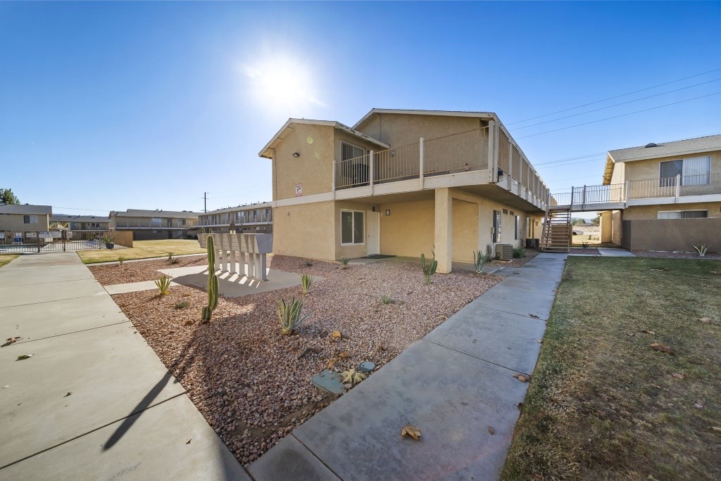 A sunny day at a residential complex with a clear blue sky.
