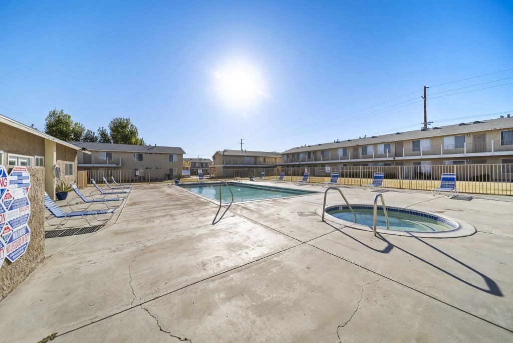 A sunny day at the outdoor pool with loungers and a clear blue sky.