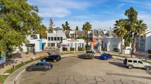 A parking lot with cars and a building in the background.