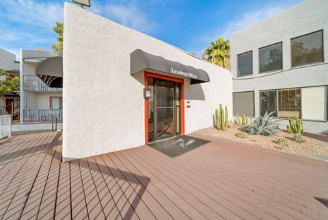 A building with a red door and a sign that says "Leasing Office".
