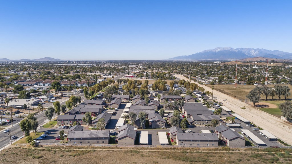 A residential area with houses and a mountain in the background.