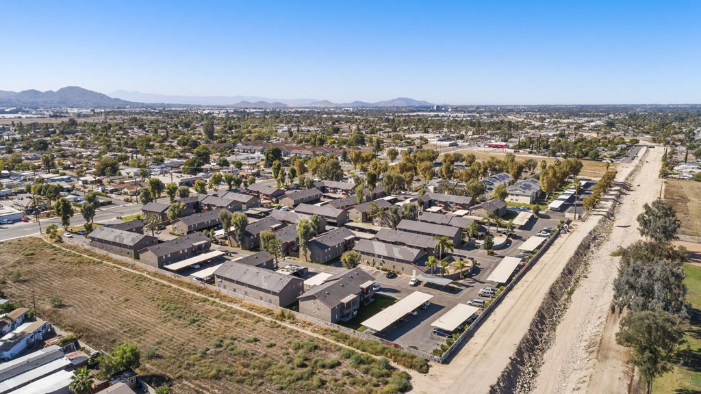 A bird's eye view of a residential area with houses and a road.