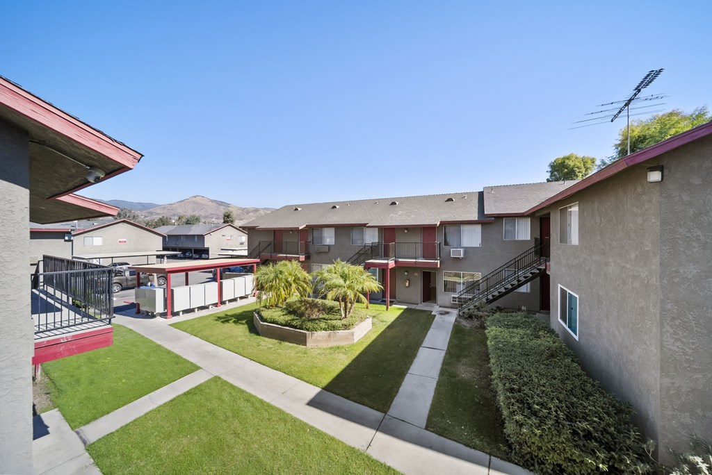 A sunny day at a residential complex with a clear blue sky.