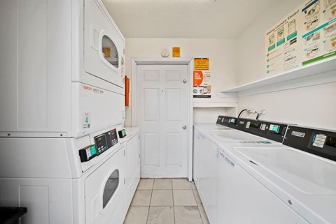 A white laundry room with a washer and dryer.