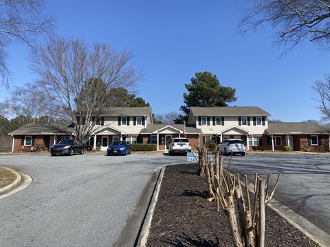 A car is parked in front of a house.