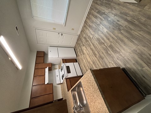 A kitchen with a stove top oven and a sink.