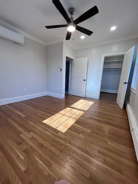 A room with a ceiling fan and wooden flooring.