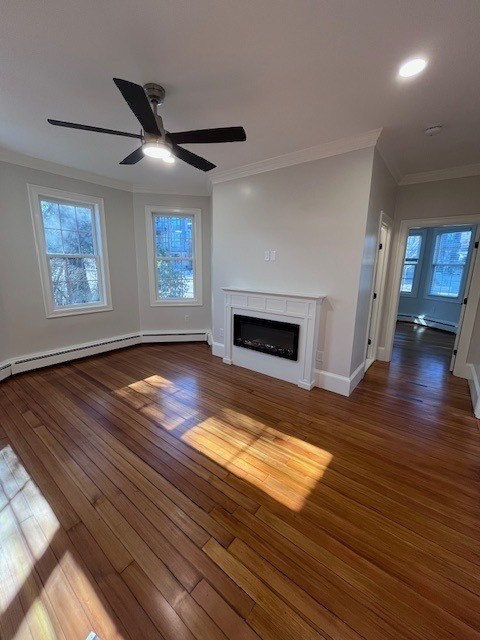 A room with a fireplace and wood flooring.