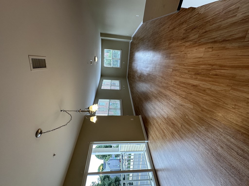 looking down the hallway from the top of the stairs into the living room