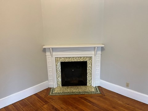 a fireplace in a living room with a rug
