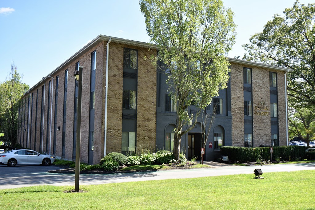 a large brick building with a tree in front of it
