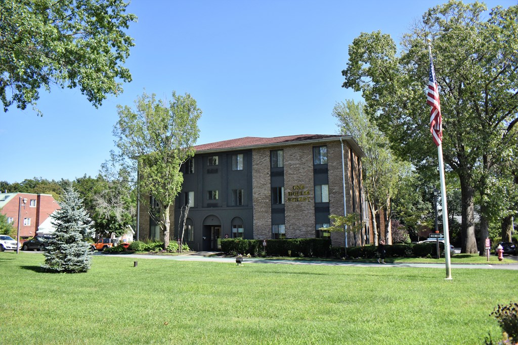 a large brick building with an american flag in front of it
