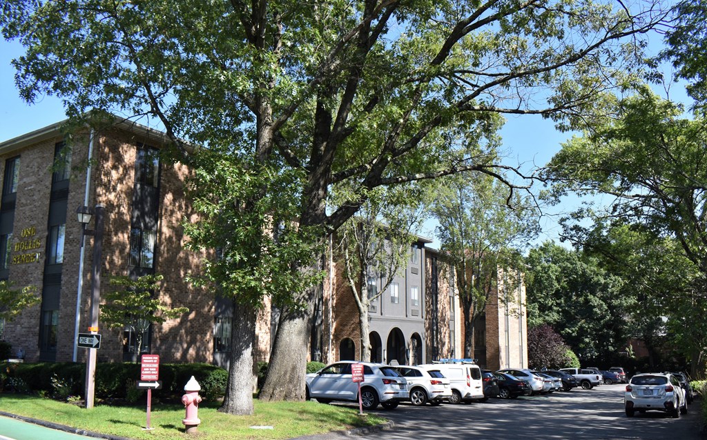a large brick building with trees in front of it
