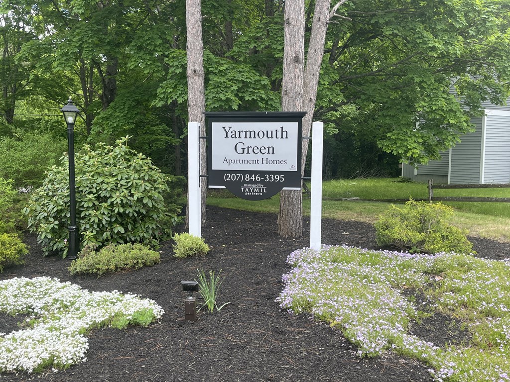 a yard with a sign for yarmouth green apartment homes