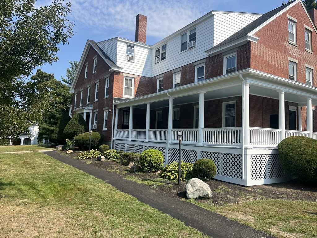 a large brick house with a white porch and a white