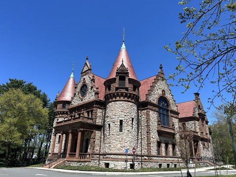 A large castle-like building with a red roof and turrets.