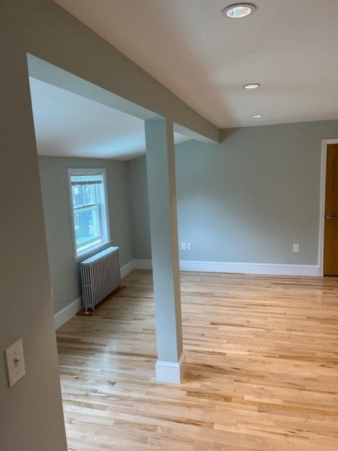 a living room with wood floors and blue walls