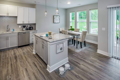 A kitchen with a table and chairs in the middle of the room.