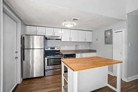 a kitchen with stainless steel appliances and a wooden counter top