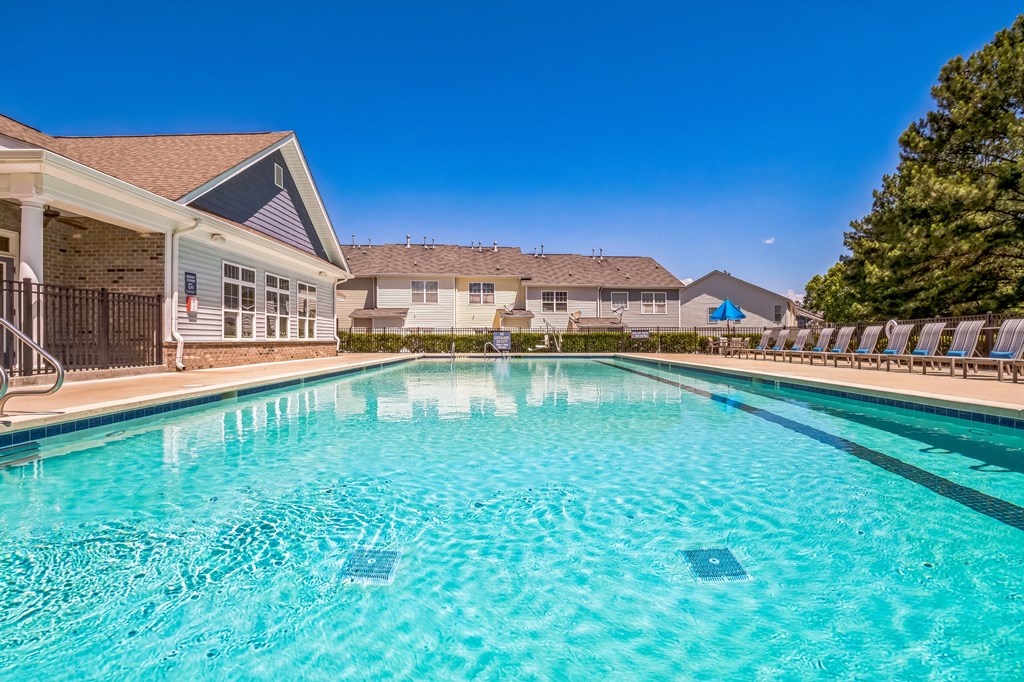 A swimming pool in a residential area with houses in the background at The Atlantic Mountain Island, Charlotte