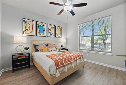 A bedroom with a bed, a ceiling fan, and a window with blinds at The Atlantic Highland Park, Texas, 75209