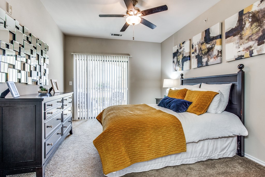 a bedroom with a bed and a ceiling fan at Village of Hawks Creek Apartments, Westworth Village Texas