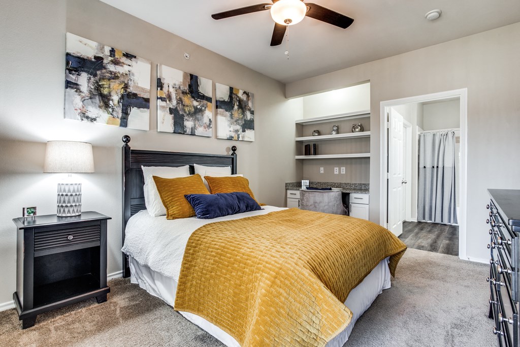 a bedroom with a bed and a ceiling fan a bedroom with a bed and a ceiling fan at Village of Hawks Creek Apartments, Westworth Village, 76114