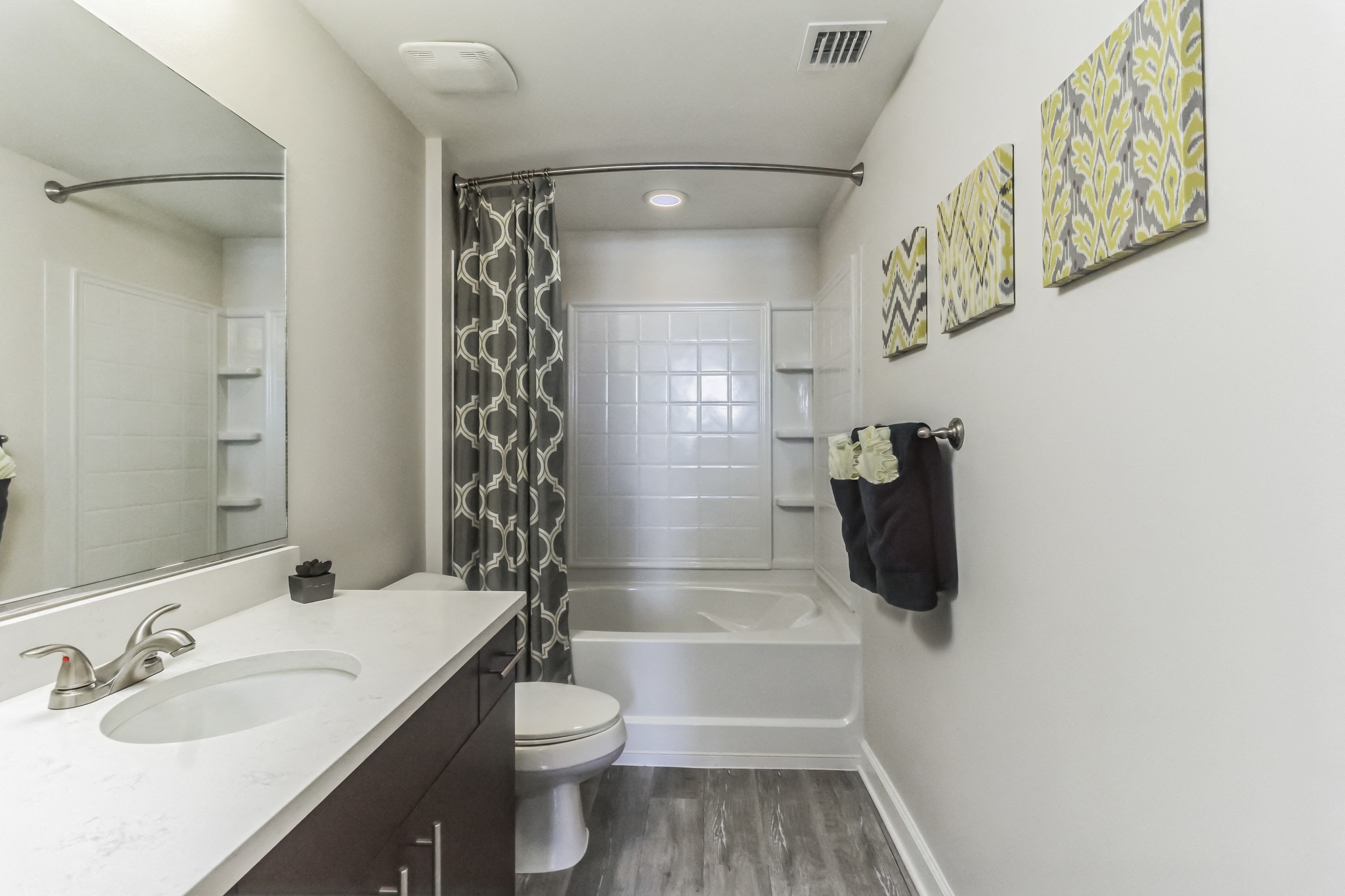 a bathroom with a shower and a sink and a toilet