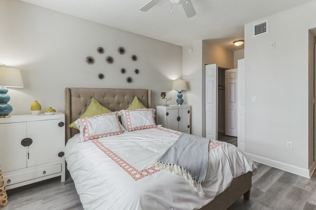 a bedroom with a large bed and a ceiling fan