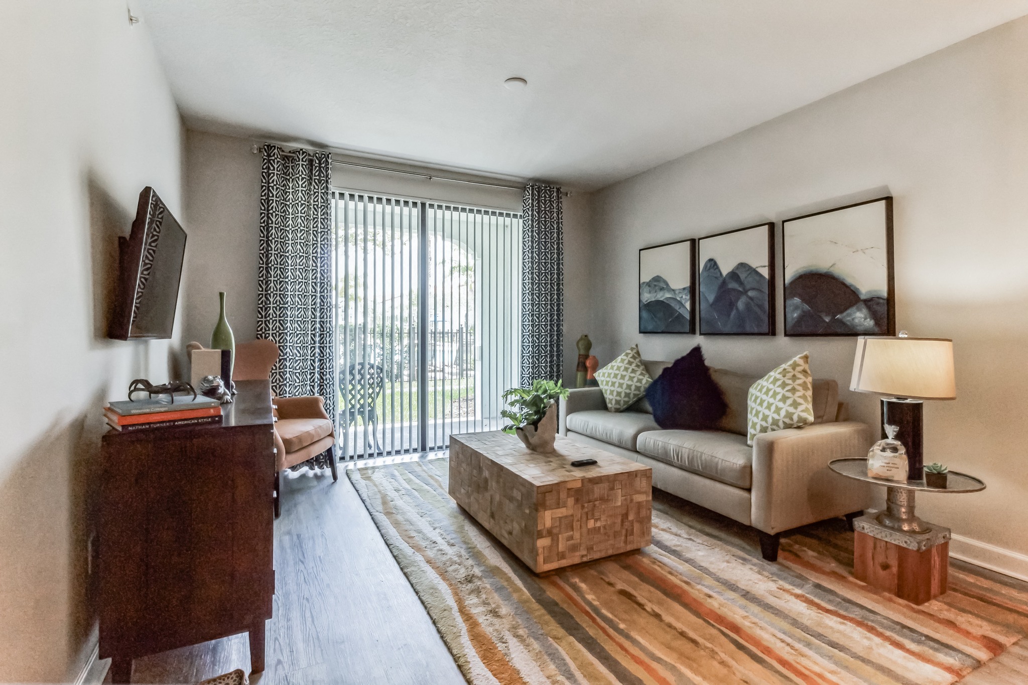 an open living room with a sliding glass door to a balcony