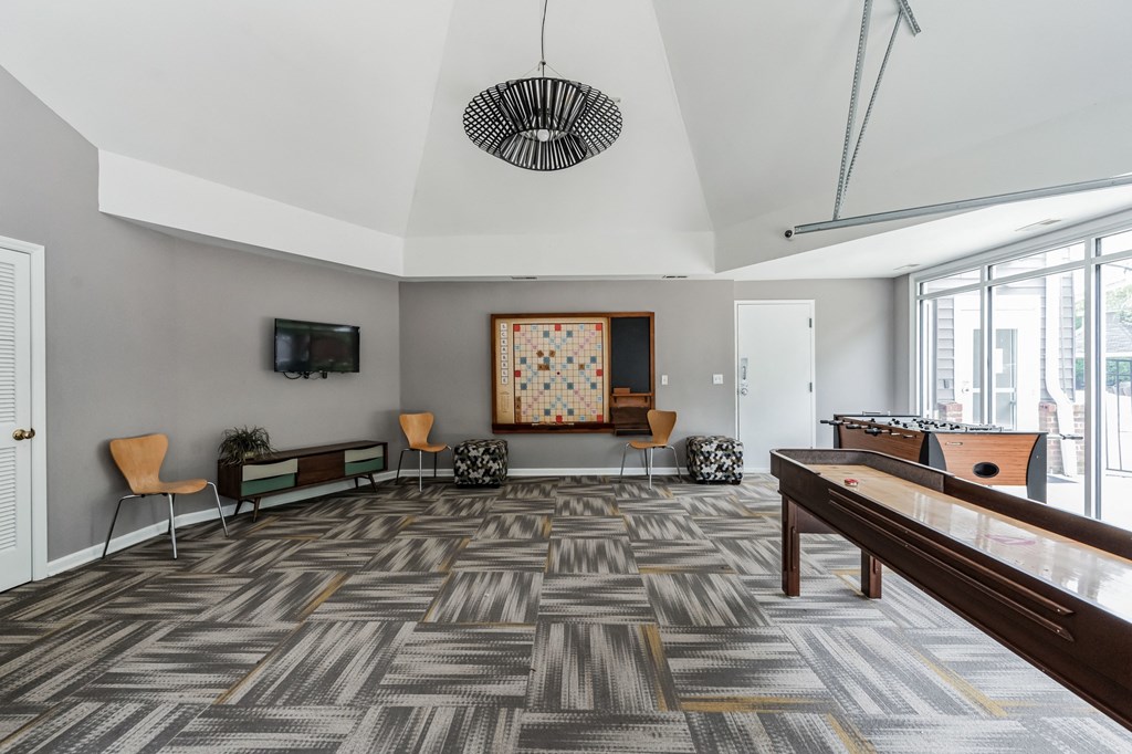 a living room with a pool table and a tv a living room with a pool table and a tv at Harrison Grande, Cary, North Carolina