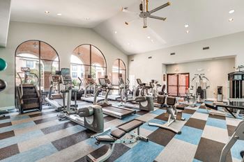Spacious fitness center with treadmills and elliptical machines at Vintage Park Apartments, Houston, Texas
