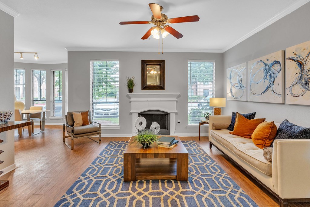 Living room with a couch and a coffee table and a fireplace at Vintage Park Apartments, Houston, Texas