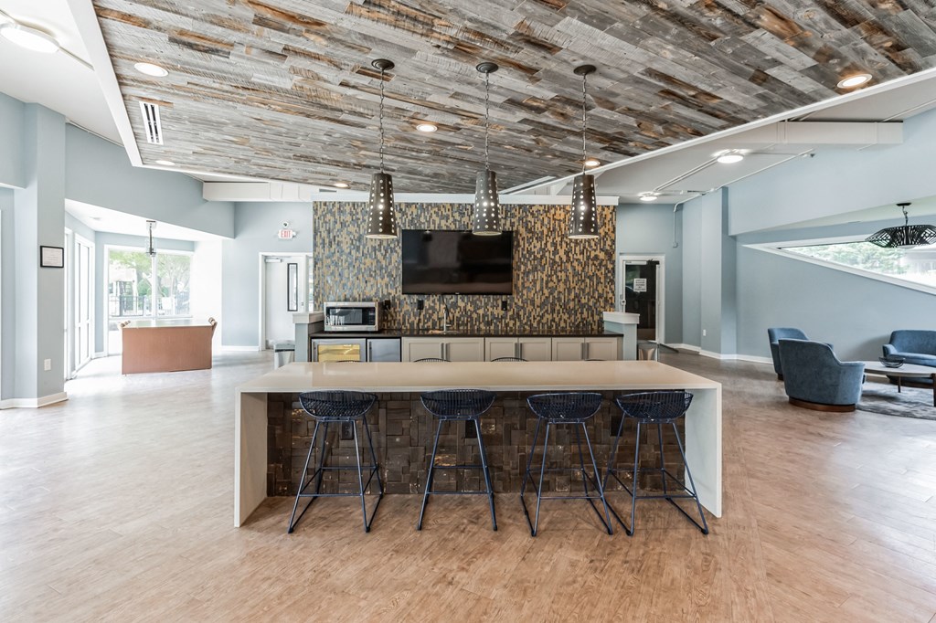 Kitchen with bar stools and a tv in a room with a living room  at Harrison Grande, Cary, North Carolina