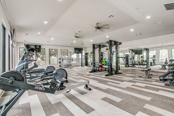 weights and cardio equipment in gym at The Atlantic Stone Oak Apartments, San Antonio Texas