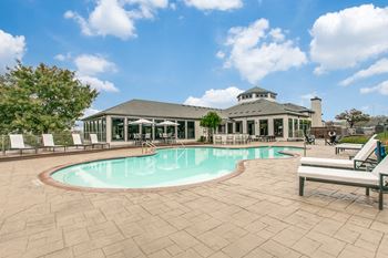 Large swimming pool with chairs at The Atlantic Stone Oak Apartments, San Antonio, 78260