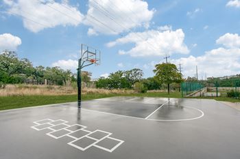 playground with trees at The Atlantic Stone Oak Apartments, San Antonio