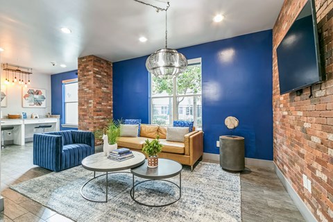 a living room with a blue wall and a couch and a table